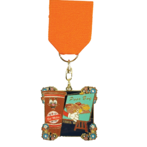 2025 Bill Miller and Laguna Madre Fiesta medal. One side represents our Bill Miller brand, showcasing Sweetie holding a paintbrush and painting a Poor Boy sandwich, fries, and pickles and onions on a teal canvas. The other side of the medal represents our Bill Miller Laguna Madre Seafood Company, showcasing two shrimp on a beach background holding paintbrushes and painting the Laguna Madre ship with a sunset. The medal has a square-shaped frame, adorned with colorful floral embellishments at each corner.